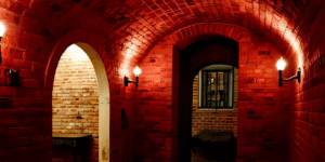 Dimly lit brick tunnels inside the Amsterdam Dungeon, part of the dark history of Amsterdam attraction
