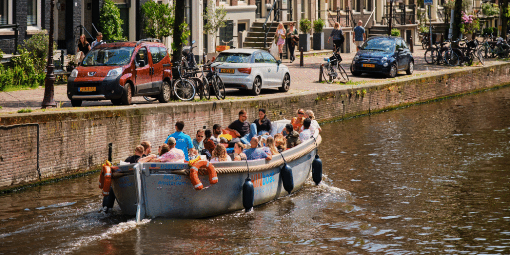 Open KINboat on a calm day with 360-degree views along Amsterdam canals.